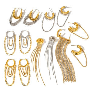Set of gold and silver stainless steel chain tassel earrings and ear cuffs on white background