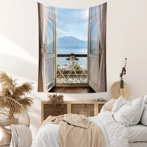 Detail view of a boho wall tapestry showing a balcony window with serene lake and mountain views