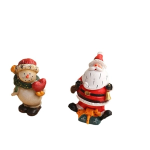 Resin Christmas ornaments featuring Santa Claus and a snowman for holiday tree decoration