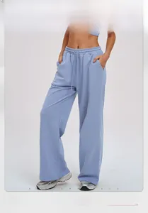 Detail of high-waist loose wide-leg blue sweatpants with drawstring and side pockets