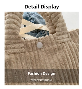 Close-up of beige corduroy bucket bag showing texture, white snap button, and thick handle