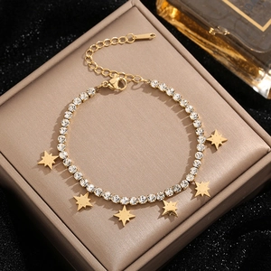 Golden titanium steel bracelet with sparkling crystals and eight-point star pendants