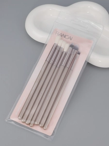 Close-up of professional 8-piece champagne gold eye makeup brush set in retail packaging