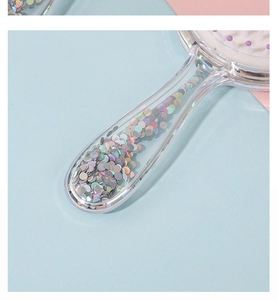 Detailed macro view of a clear plastic comb handle filled with colorful sequins