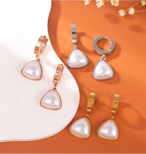 Detailed view of triangular pearl pendants in rose gold, silver, and gold finishes