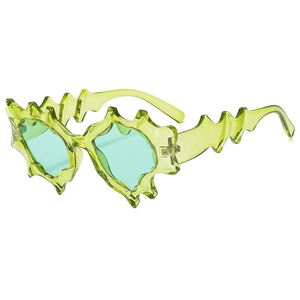 Futuristic avant-garde punk sunglasses with jagged flame frames in transparent green