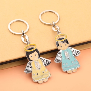 Detail of colorful enamel cartoon angel keychains with metallic wings and silver rings