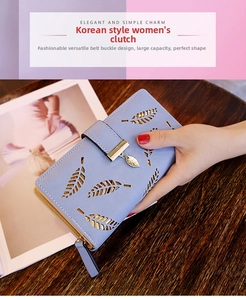 Detail of light blue wallet with hollow leaf design and golden leaf zipper puller