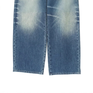Mid-waist loose fit blue distressed jeans with rolled hems and faded denim texture