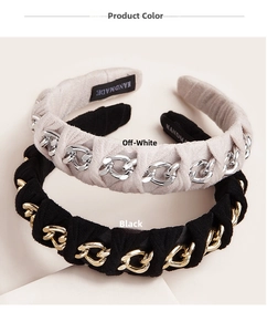 Detail of off-white and black fabric headbands with woven metal chain decorations