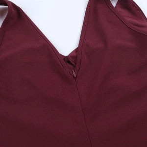 Detailed close-up of V-neckline and invisible zipper on dark burgundy evening dress