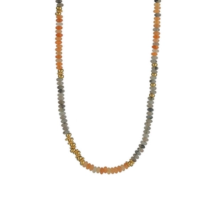 Detail of bohemian handmade beaded necklace with orange, grey and gold spacers on white background