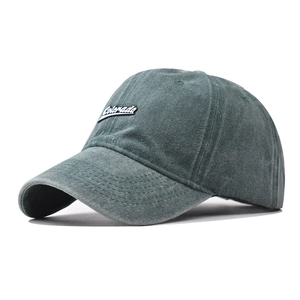 Detail of washed cotton baseball cap in dark green featuring Colorado embroidered patch