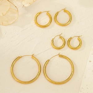 Three pairs of polished gold stainless steel hoop earrings in small, medium, and large sizes