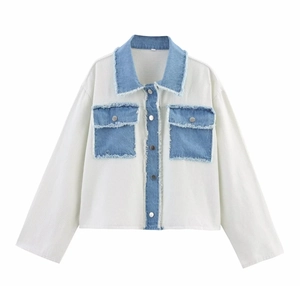 Detail of a white cropped jacket with blue denim patchwork and frayed edge details