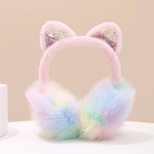 Detail of plush rainbow earmuffs with sequined cat ears on a white platform