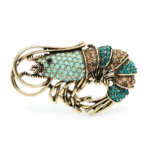 Vintage oversized lobster brooch featuring blue and amber rhinestones on bronze base