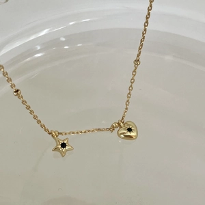Gold star and heart charm necklace with black gemstones on a minimalist link chain