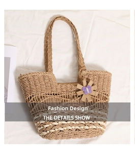 Detail of hollow-out straw woven shoulder bag featuring purple butterfly floral charm