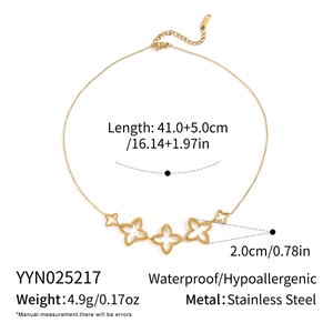Detailed view of hollow floral clover charms on a gold-plated stainless steel necklace