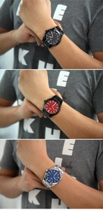 Macro view of octagonal steel bezel and tapisserie dial in black, red, and blue colors