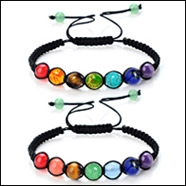 Detail of adjustable braided cord bracelet with seven colorful chakra gemstone beads
