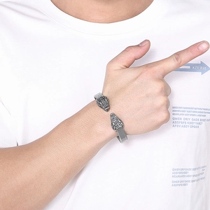 Close-up of retro stainless steel mesh bracelet with double leopard heads on wrist