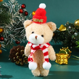 Detail of cute beige plush bear wearing a red LOVE hat and striped Christmas scarf