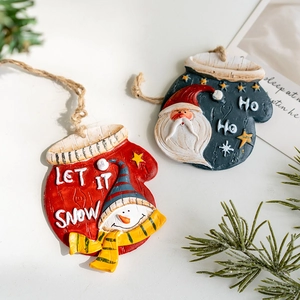 Vintage resin Christmas glove ornaments featuring snowman and Santa Claus designs