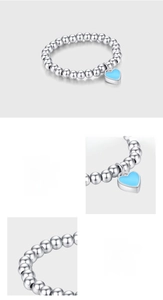 Detailed view of S925 sterling silver beaded ring featuring a light blue enamel heart charm