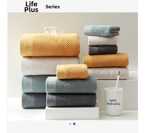 Detail shot of stacked cotton towels with geometric diamond textures in four colors