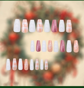 Detail of Christmas press-on nails with snowflake, pink glitter and heart embossing