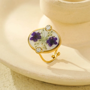 Gold stainless steel ring with purple dried flowers in resin and adjustable band