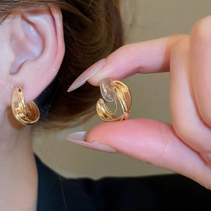 Elegant gold-tone intertwined C-shaped ear clips with comfortable soft silicone pads