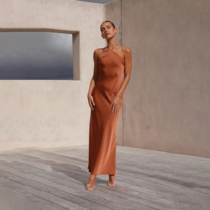 Detail of rust red halter neck backless satin maxi dress with silky glossy texture