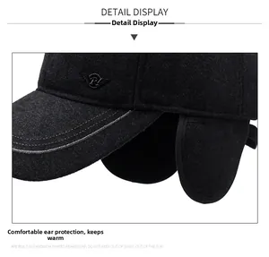 Detailed view of winter hat with ear flaps, thick wool fabric and metal wing logo