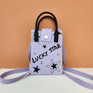 Detail of lavender woven phone bag with star pattern and Lucky Star text embroidery
