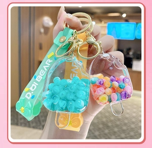 Detail of colorful popsicle liquid keychains in mint green and lemon yellow with beads