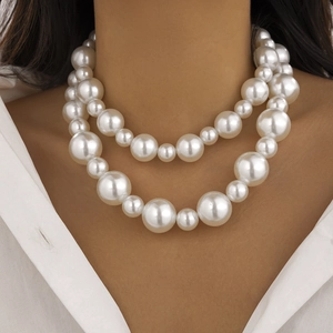 Close-up of double-layer oversized faux pearl necklace with glossy white beads