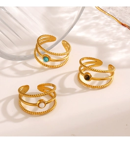 Detail of 18K gold stainless steel rings set with turquoise and tiger eye stones