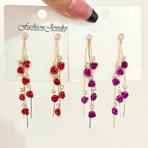 Elegant long rose flower drop earrings with rhinestones and tassel hanging on card