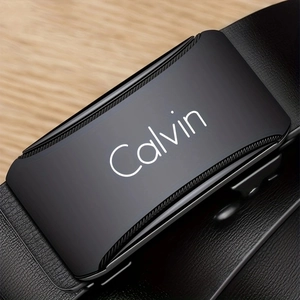Close-up of black alloy automatic belt buckle with brushed metal texture and logo