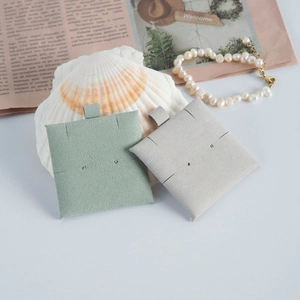 Microfiber jewelry display pads in mint and grey with hanging loops and stud holes