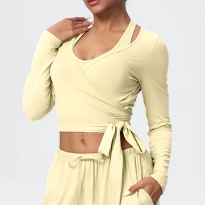 Detail of light yellow wrap V-neck yoga top with adjustable waist ties and slim fit design