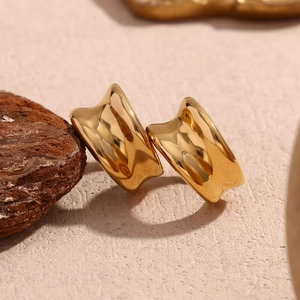 Minimalist 18K gold plated stainless steel concave earring on rustic stone pedestal
