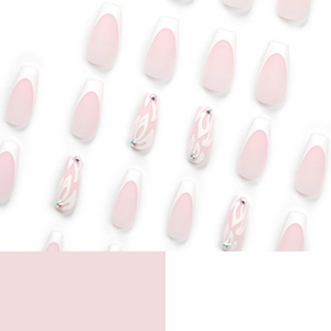 French tip press-on nails in light pink with white floral patterns and rhinestones