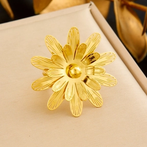 Detailed macro view of gold plated layered hollow petal flower ring on display box