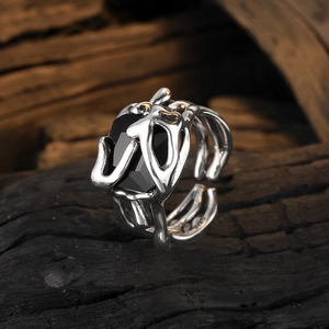 Vintage silver multi-layer open ring with black zircon stone on textured wood background