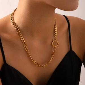 Close-up of chunky gold stainless steel Cuban chain necklace with round clasp on model