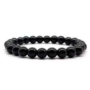 Macro shot of 8mm polished black agate beads on an elastic stretch bracelet string